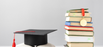 front-view-stacked-books-graduation-cap-open-book-education-day