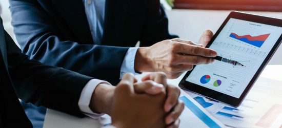 partner business man investor team brainstorming and planning about financial statistics chart information in mobile tablet together in meeting room at office, finance, investment and digital concept